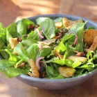 Baby spinach salad with pita croutons, dates and almonds